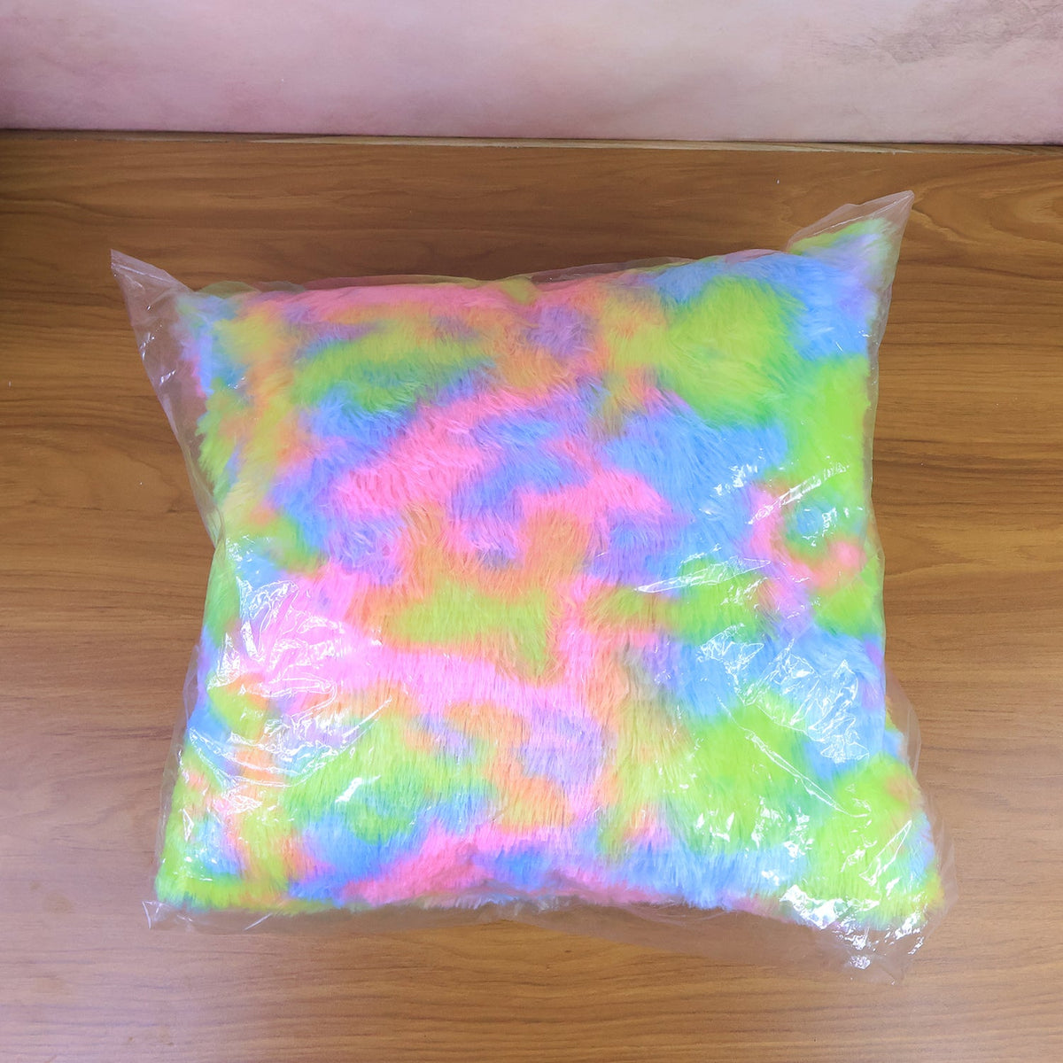 Comfortable plush throw pillow with rainbow design in living room
